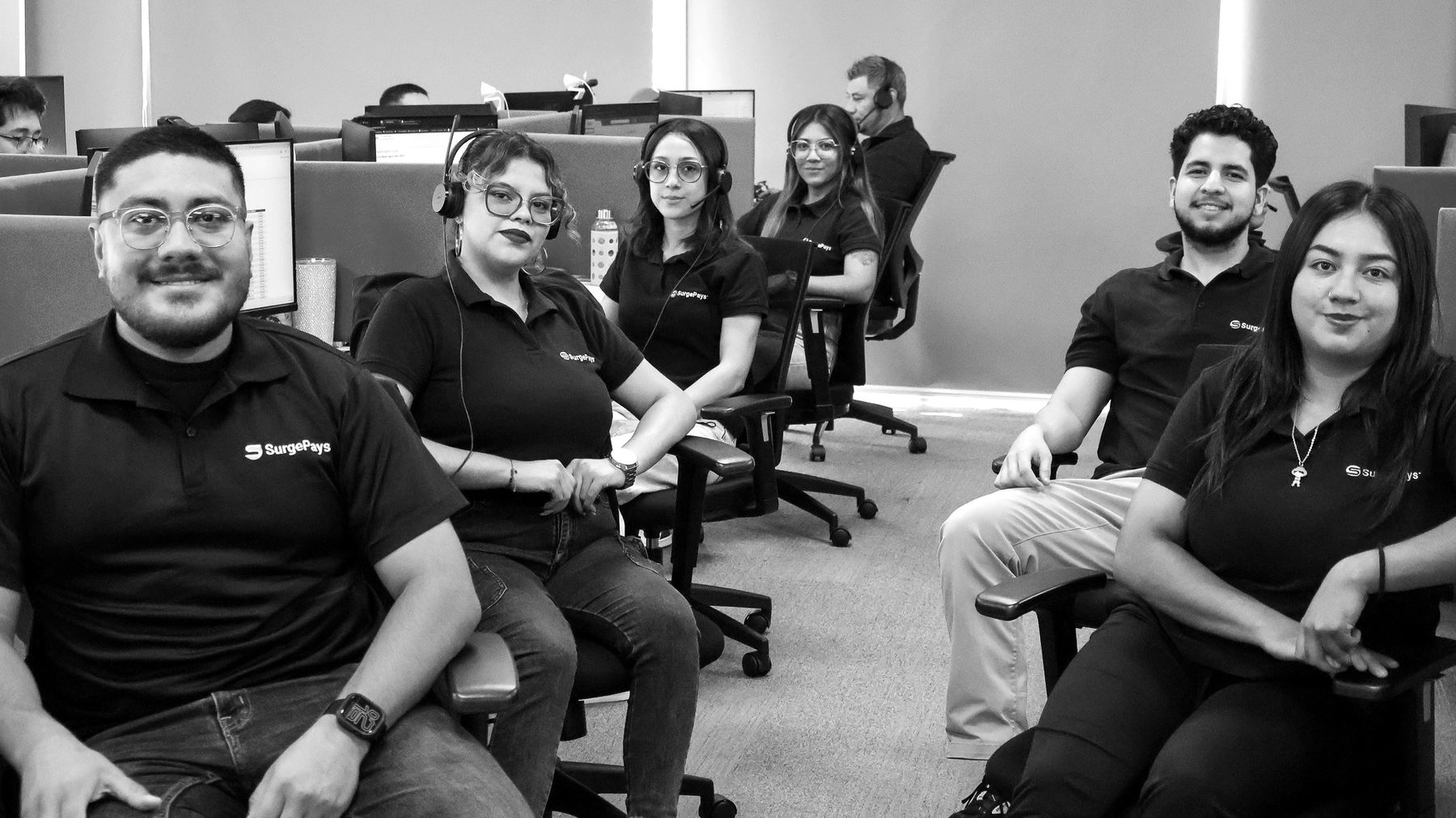 SurgePays operations center team members at their desks